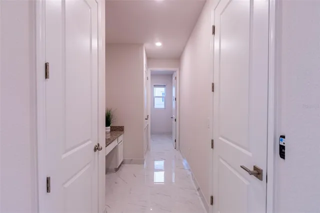 a view of a hallway with closet and wooden floor