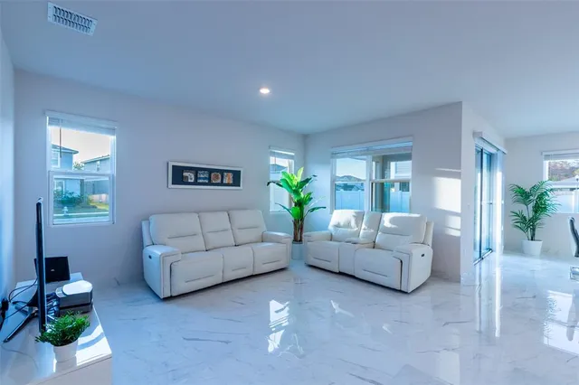 a living room with furniture and a potted plant