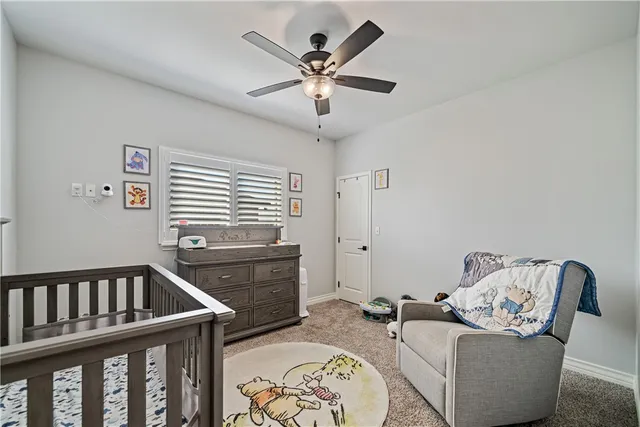 a livingroom with furniture window and a ceiling fan