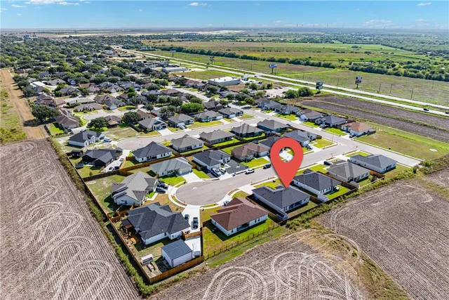 an aerial view of a house with a swimming pool