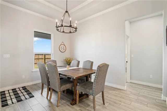 a view of a dining room with furniture wooden floor and chandelier