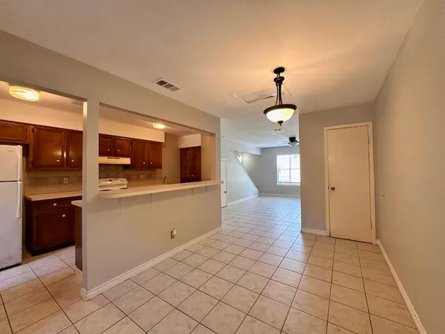 a view of a kitchen with a sink and a refrigerator