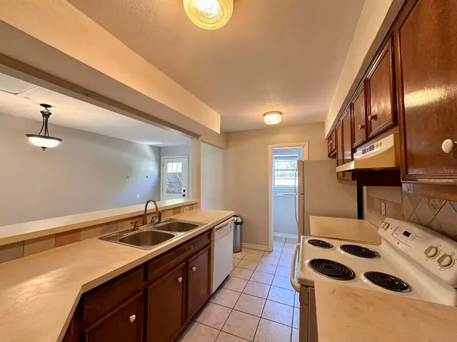 a kitchen with a sink stove and cabinets