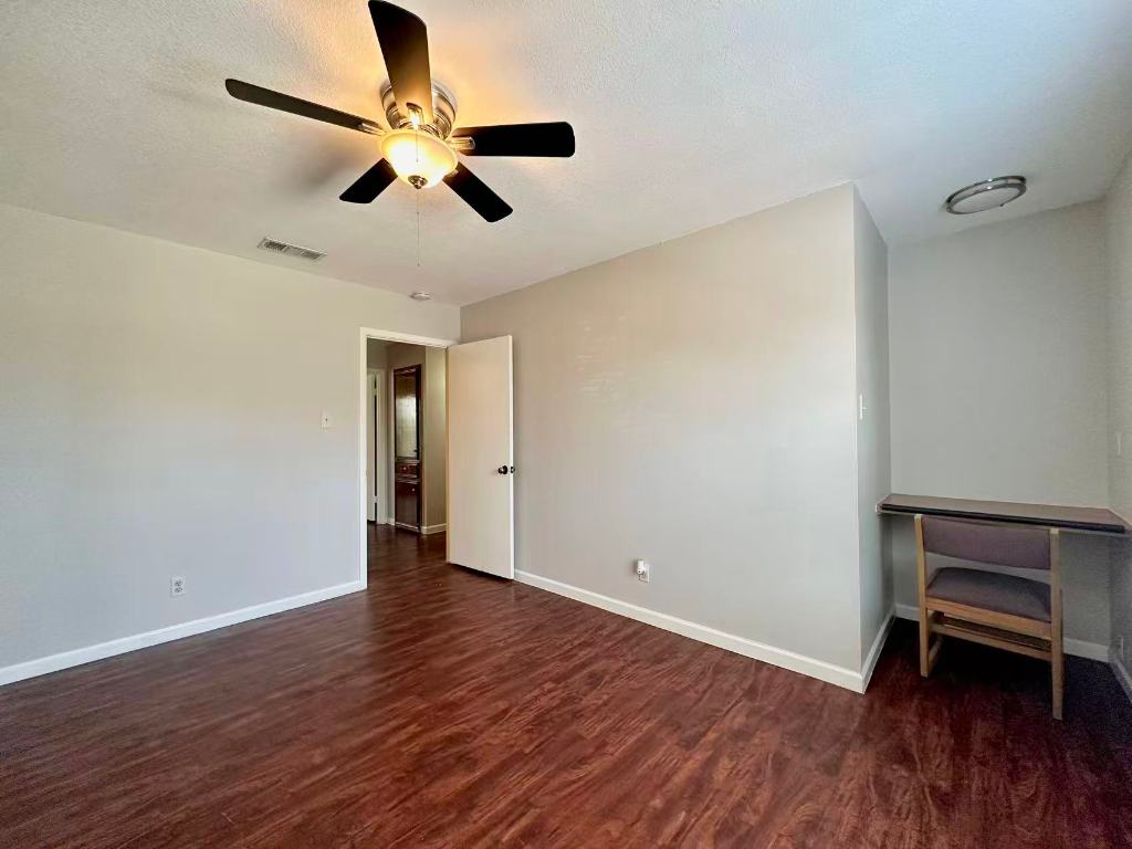 202 2nd Street North, Unit D Pflugerville, TX 78660 - Photo 9 of 15 wooden floor in an empty room with a window