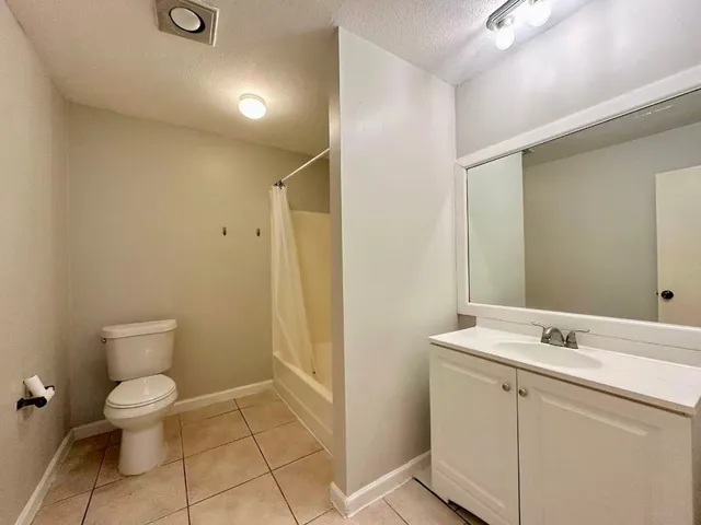 a bathroom with a toilet sink and a mirror