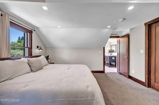 a view of a hallway to a livingroom with furniture and staircase