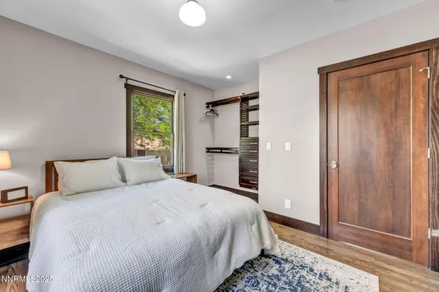 a living room with furniture a flat screen tv and kitchen view