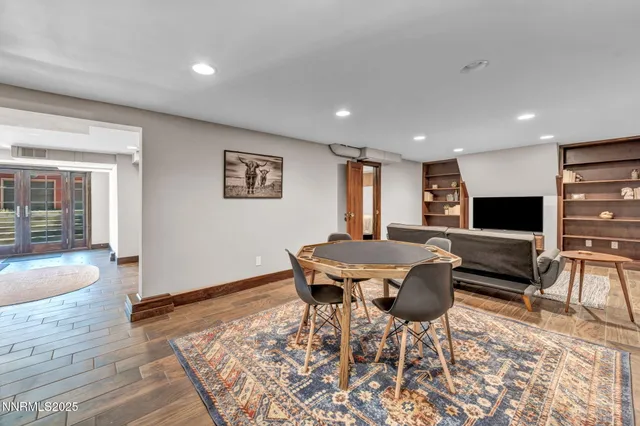 a large kitchen with a sink and dishwasher a stove top oven with wooden floor