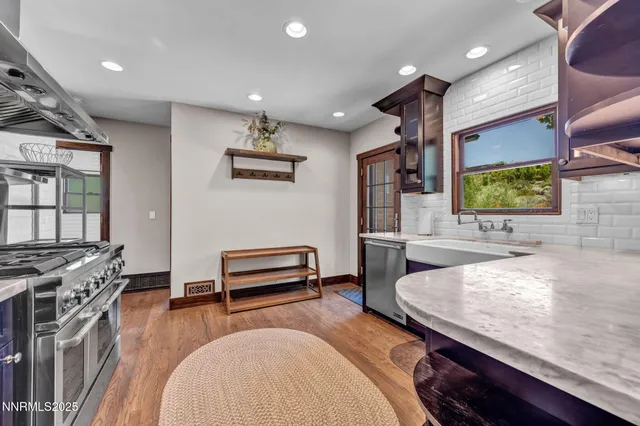 a kitchen with a table chairs and stove