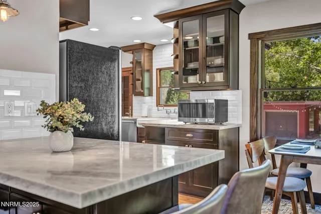 a view of a dining room with a table and chairs
