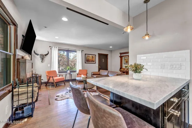 a living room with furniture a fireplace and a flat screen tv