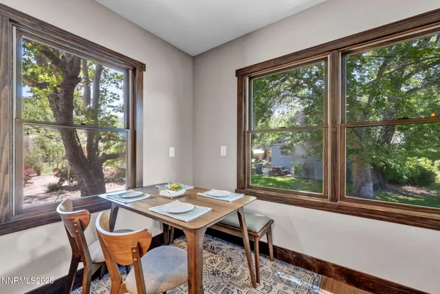 a living room with furniture a flat screen tv and a floor to ceiling window