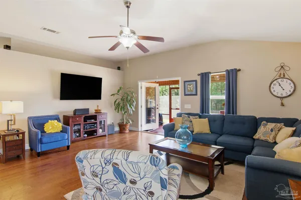 a living room with furniture and a flat screen tv