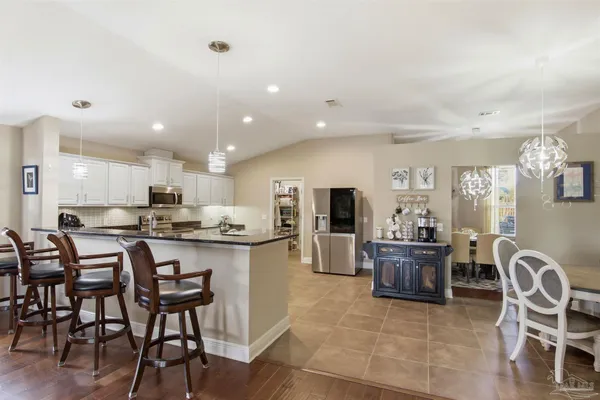 a large open kitchen with a table and chairs in it