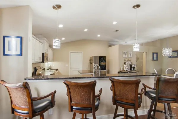 a kitchen with stainless steel appliances granite countertop a sink and cabinets