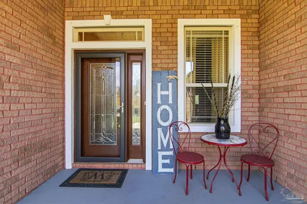 a front view of a house with outdoor seating