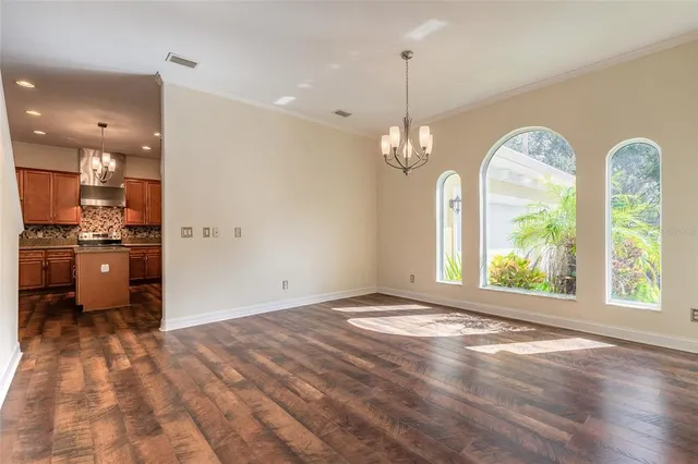 a view of a kitchen with a sink wooden floor and a hallway