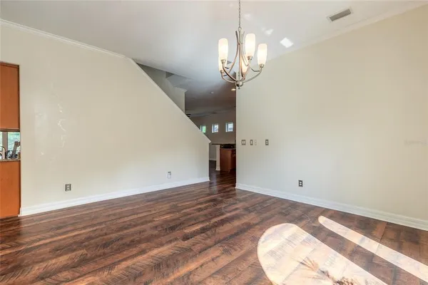 an empty room with closet and windows