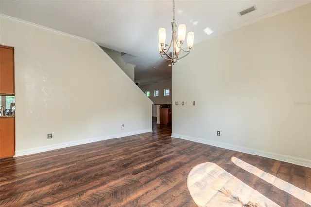an empty room with closet and windows