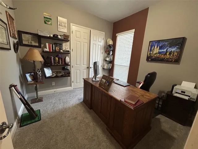 a room with furniture a air conditioner vent and a window