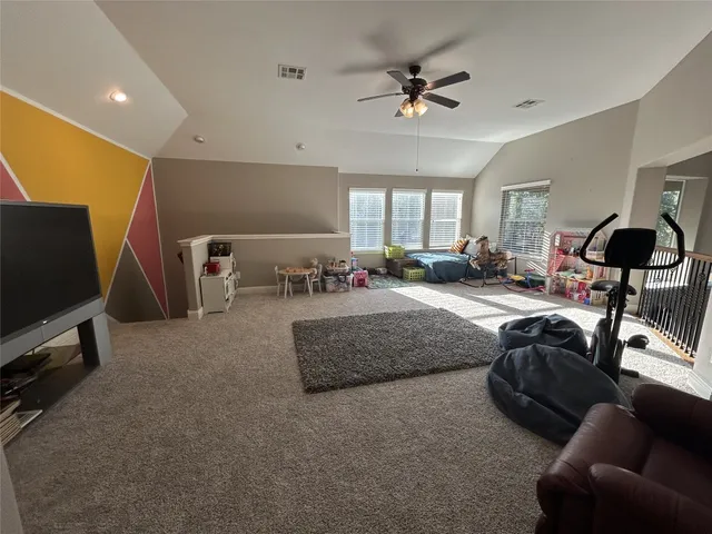 a bedroom with furniture and a flat screen tv