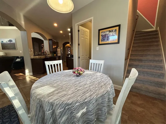 a spacious bedroom with a bed and a chandelier
