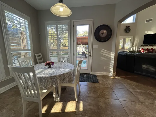 a view of a dining room with furniture and a large window