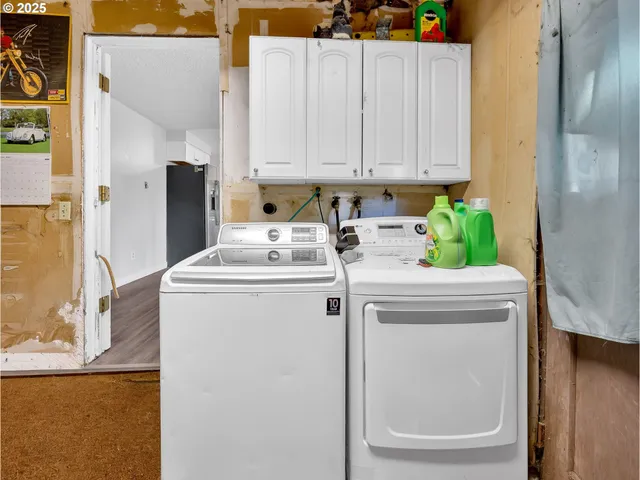 a utility room with closet dryer and washer