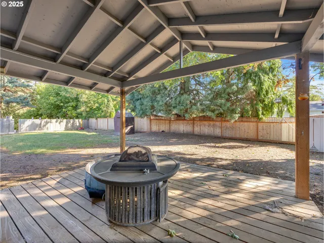 a view of a patio with table and chairs and wooden floor