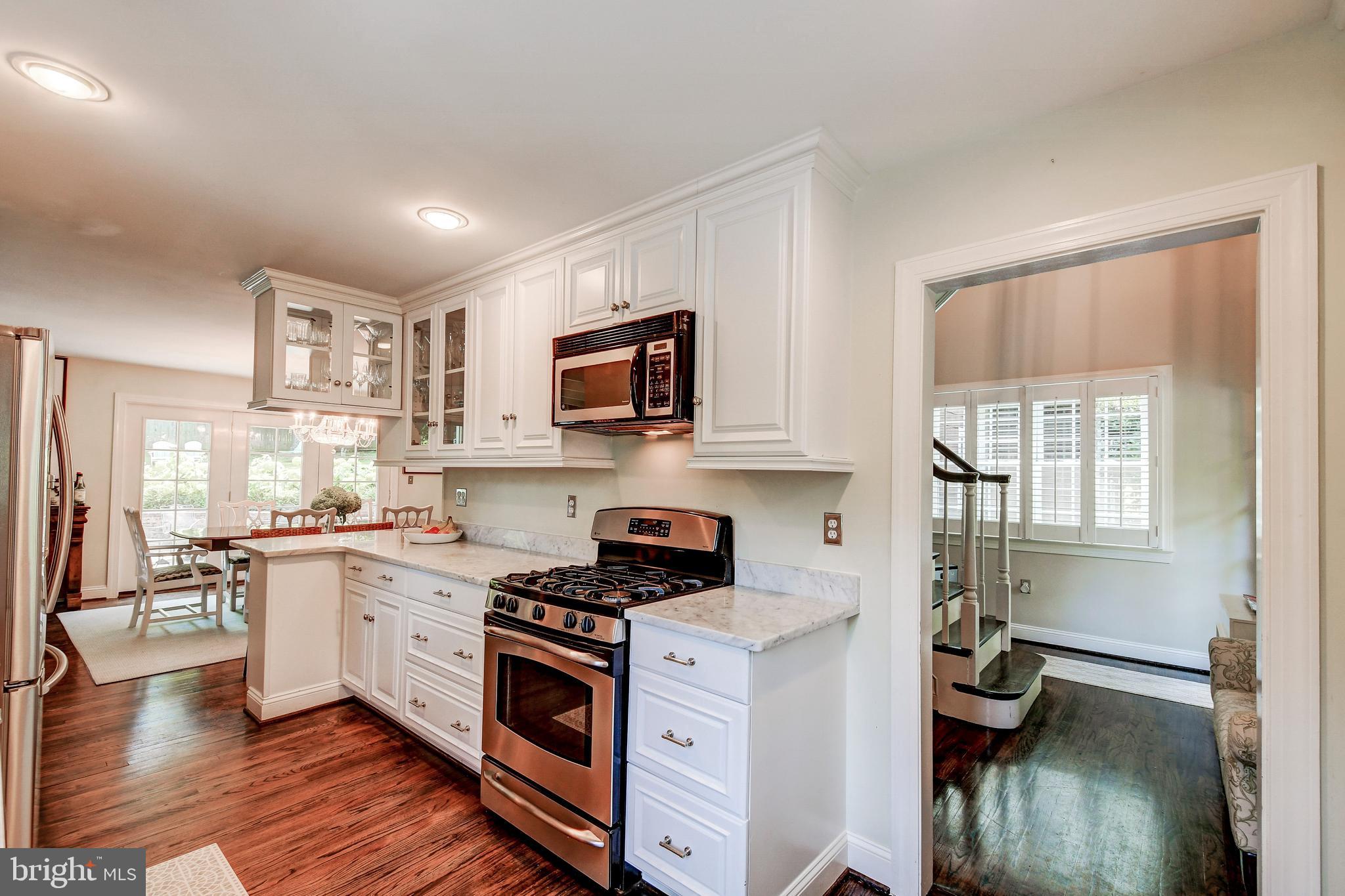 1741 Circle Road Baltimore, MD 21204 - Photo 22 of 40 a kitchen with stainless steel appliances granite countertop a stove top oven a sink dishwasher and cabinets with wooden floor