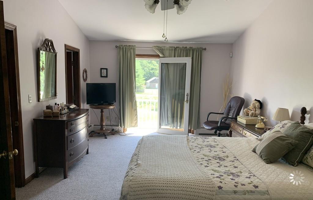 1225 Reed Road Dartmouth, MA 02747 - Photo 12 of 21 a bed room with a bed window and a chandelier