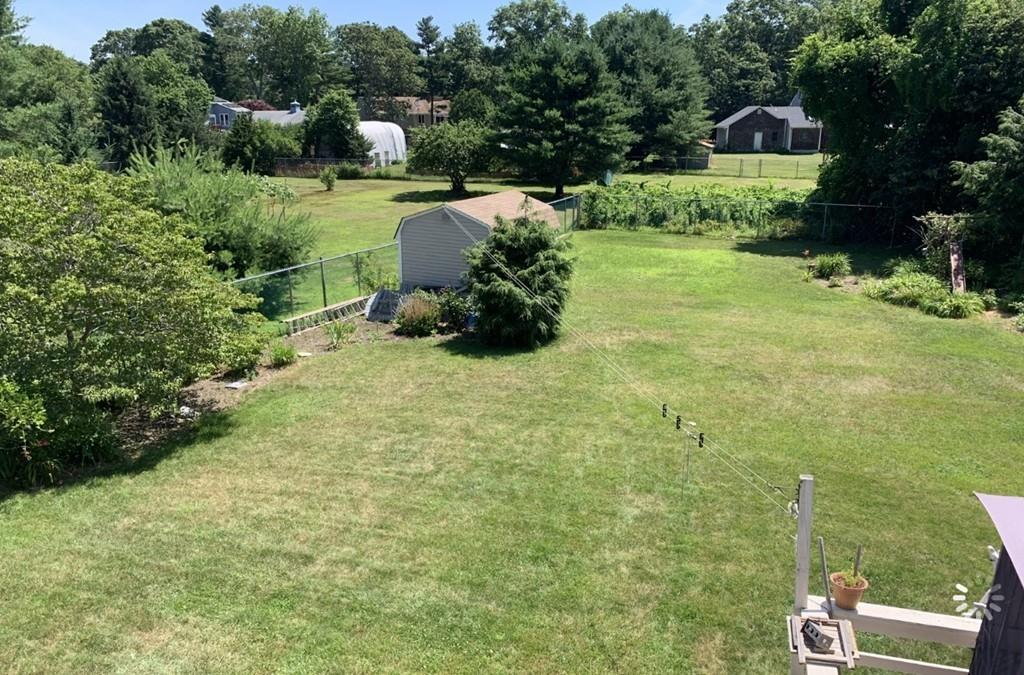 1225 Reed Road Dartmouth, MA 02747 - Photo 14 of 21 a view of a house with a yard and a garden