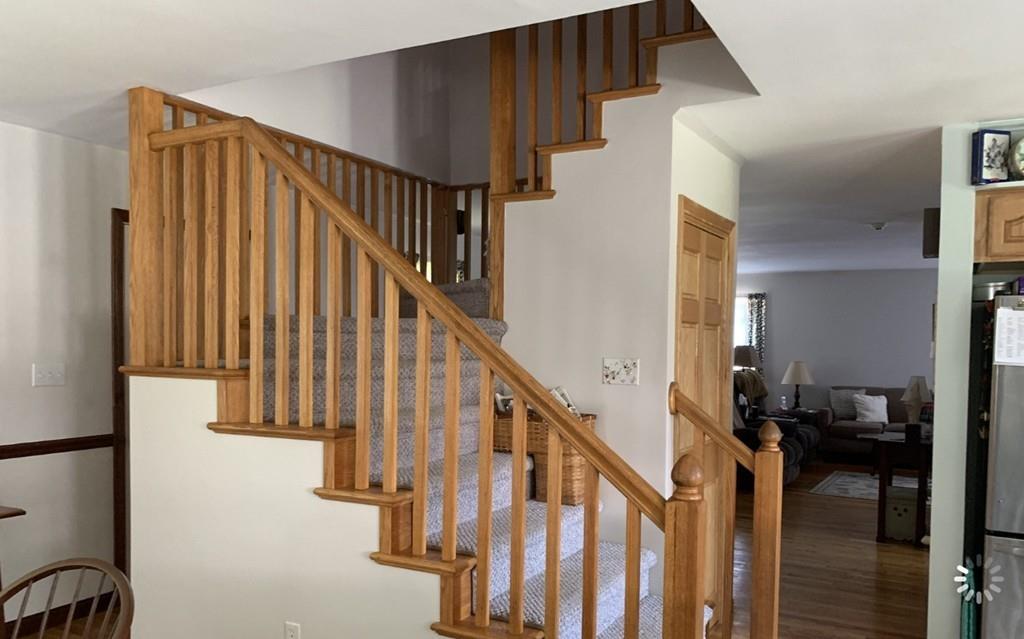 1225 Reed Road Dartmouth, MA 02747 - Photo 17 of 21 a view of staircase with lots of frames on wall and a window