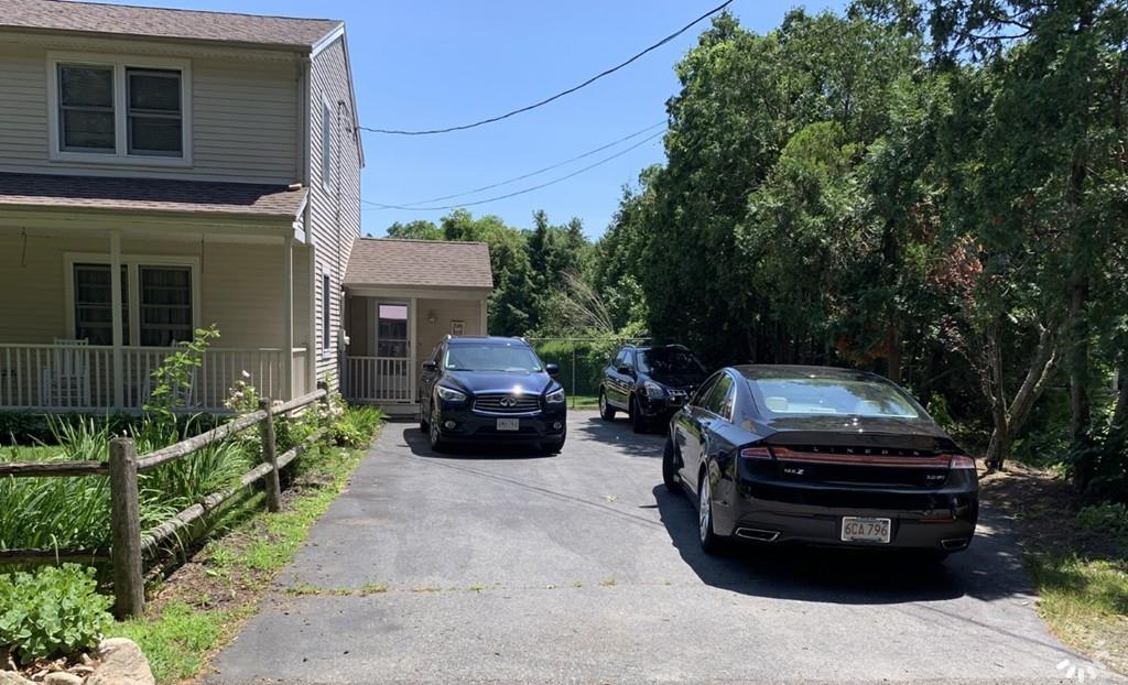 1225 Reed Road Dartmouth, MA 02747 - Photo 20 of 21 a front view of a house with a garden and parking space