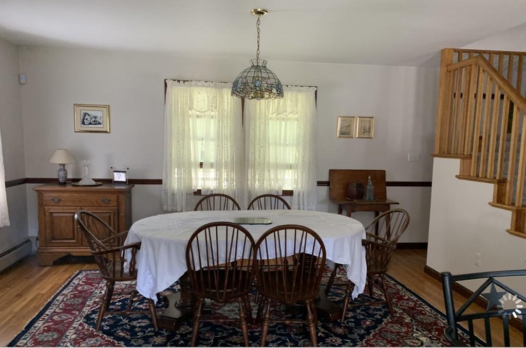 1225 Reed Road Dartmouth, MA 02747 - Photo 2 of 21 a bedroom with a bed and a chandelier