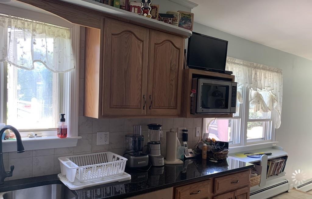 1225 Reed Road Dartmouth, MA 02747 - Photo 4 of 21 a kitchen with a stove a sink and a microwave