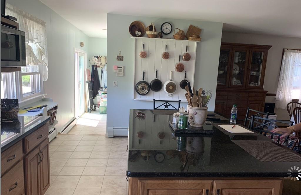 1225 Reed Road Dartmouth, MA 02747 - Photo 5 of 21 a kitchen with a refrigerator and a stove