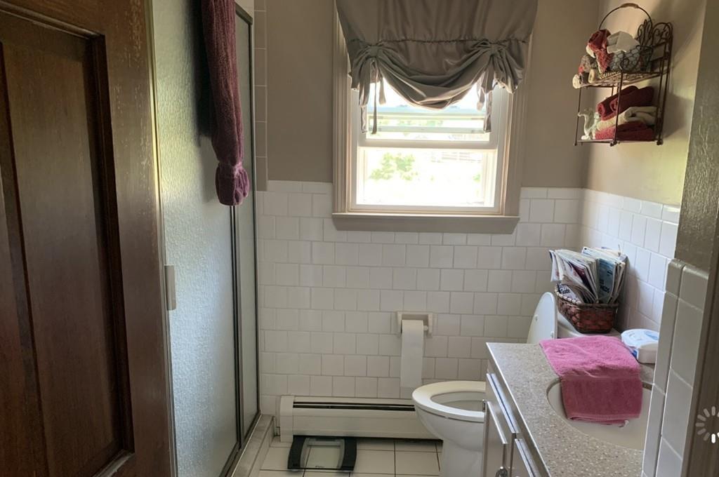 1225 Reed Road Dartmouth, MA 02747 - Photo 10 of 21 a bathroom with a sink toilet and window