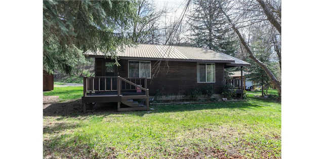 1105 Litz Road Preston, ID 83263 - Photo 21 of 24 View of front of property featuring a front yard, a metal roof, and a wooden deck