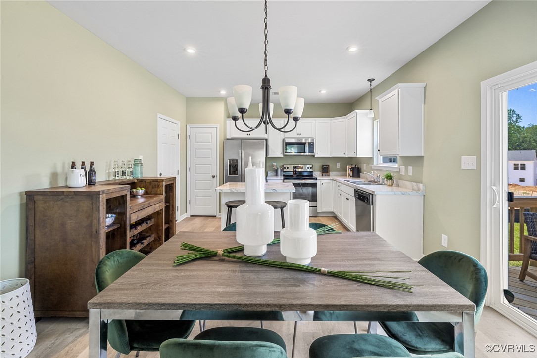 38 Central Place Aylett, VA 23009 - Photo 16 of 32 a view of kitchen with stainless steel appliances wooden floor dining table and chairs
