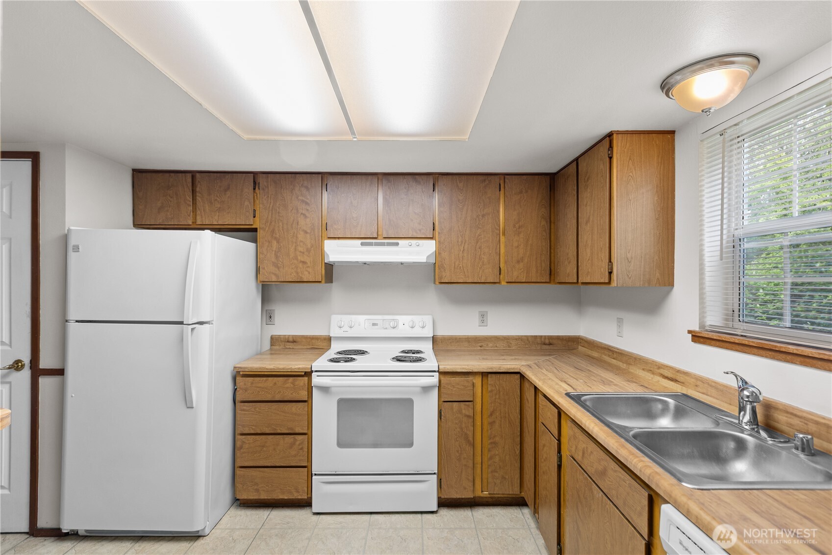 2312 Jade Avenue Everett, WA 98201 - Photo 4 of 34 a kitchen with a refrigerator sink stove and cabinets