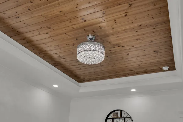 a dining room with furniture a chandelier and wooden floor
