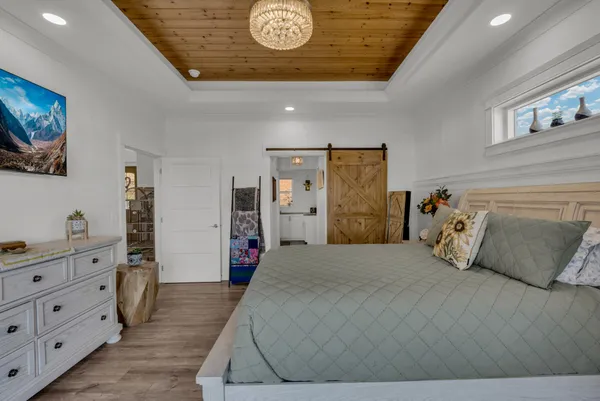 a living room with furniture a fireplace and wooden floor