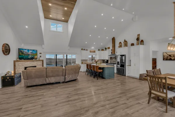 a kitchen with stainless steel appliances granite countertop a refrigerator and a stove top oven