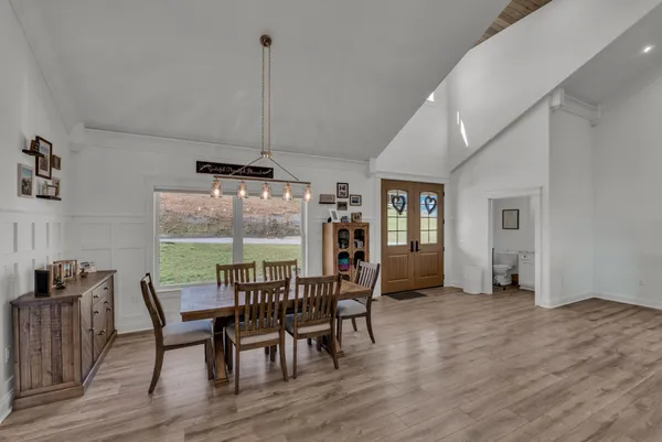 a view of a workspace with furniture and wooden floor