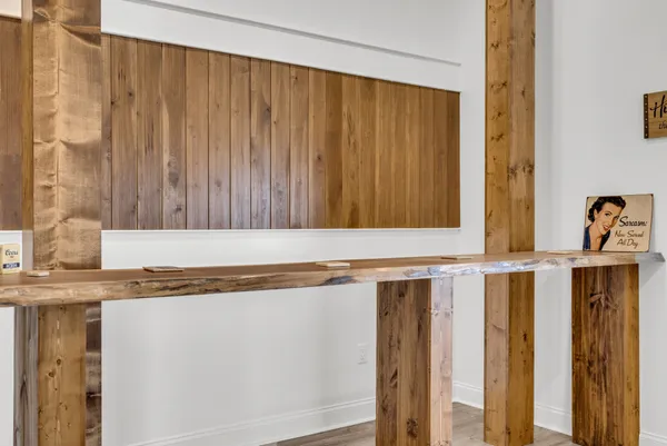 a view of a house with backyard and wooden fence