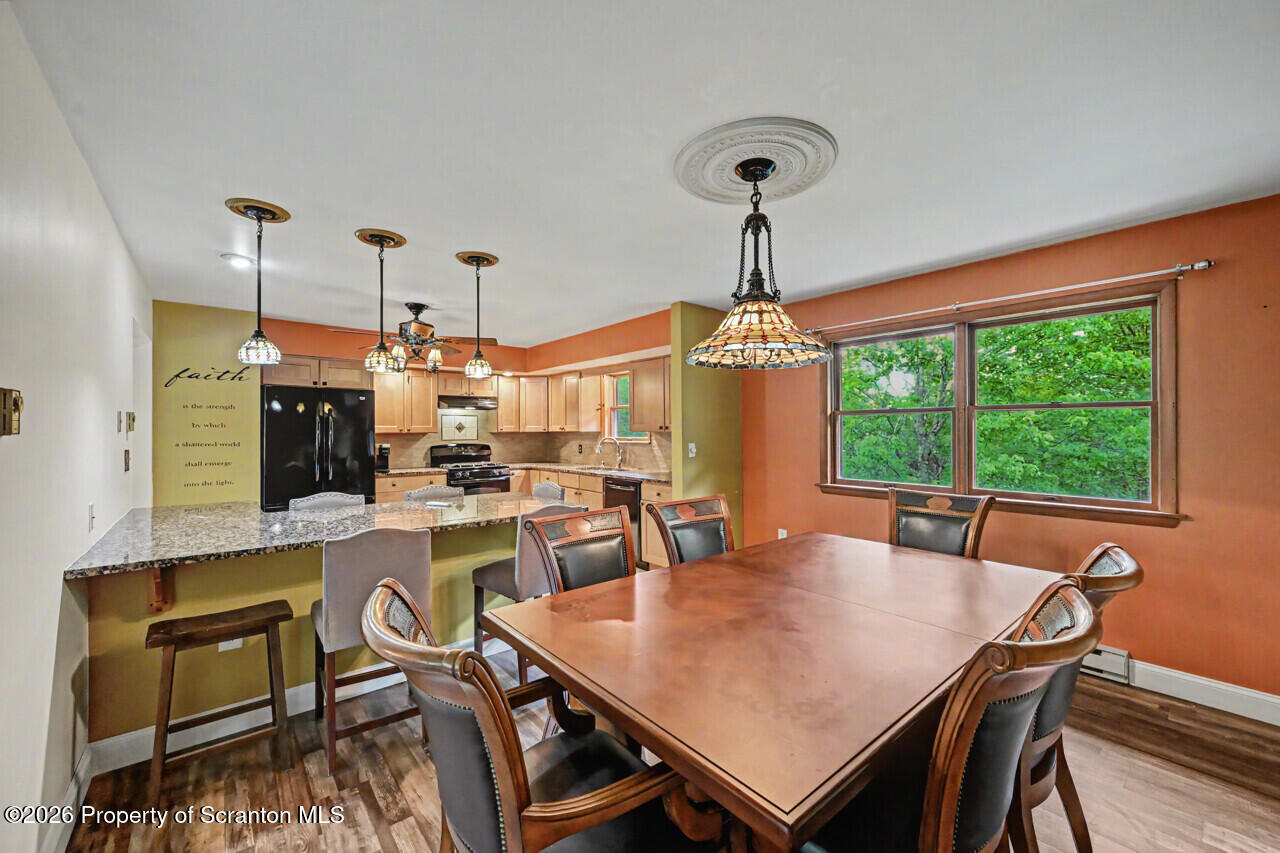 211 Buckingham Street Moscow, PA 18444 - Photo 21 of 83 a view of a dining room and livingroom with furniture wooden floor a chandelier