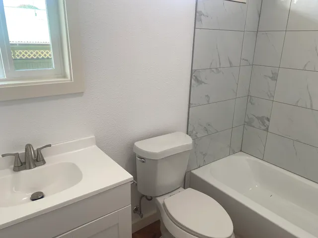 a white toilet sitting next to a bathroom sink
