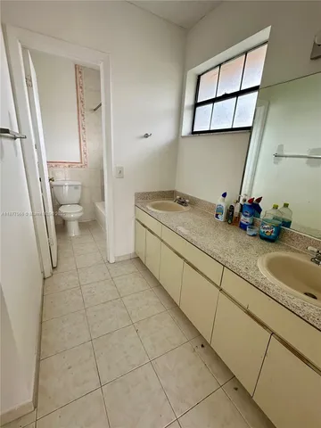 a bathroom with a toilet a sink and bathtub