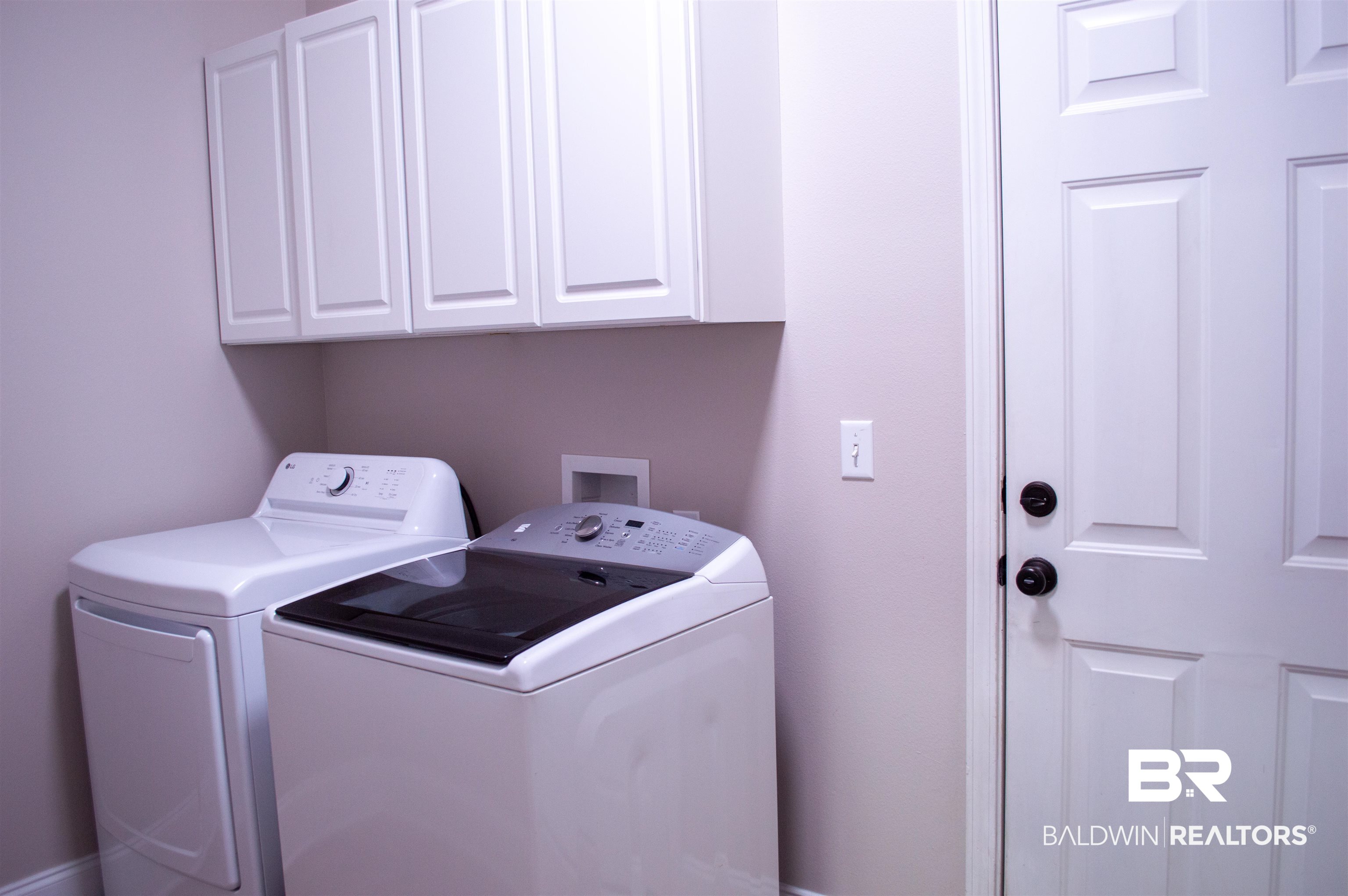 1124 West Orlando Drive Foley, AL 36535 - Photo 40 of 51 Laundry room featuring independent washer and dryer and cabinet space